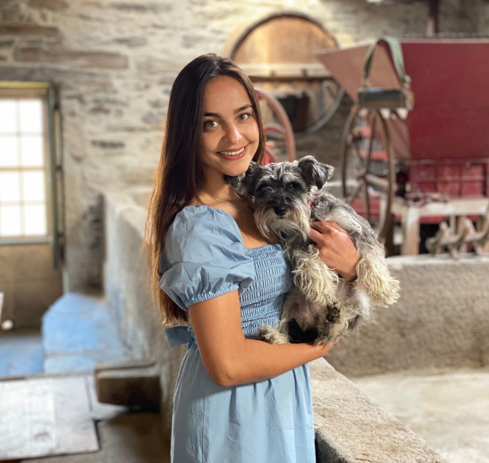 Angel Mia Horvath holding dog